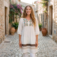 Smiling model wearing the white embroidered Mexican tunic dress
