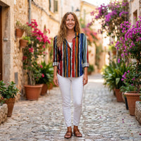 Smiling model wearing the multicolor striped boho button down shirt