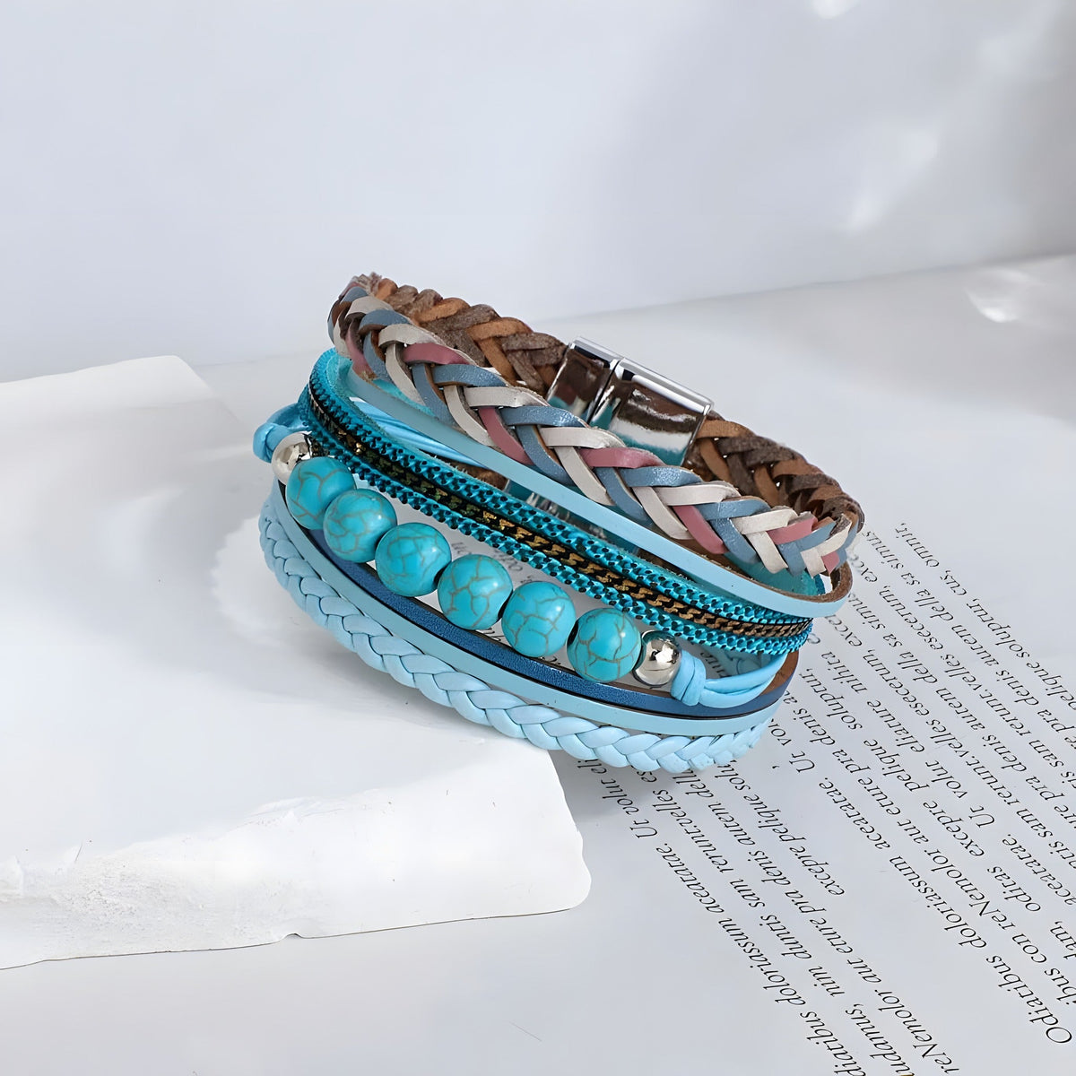 Turquoise multi strand bracelet resting on a book