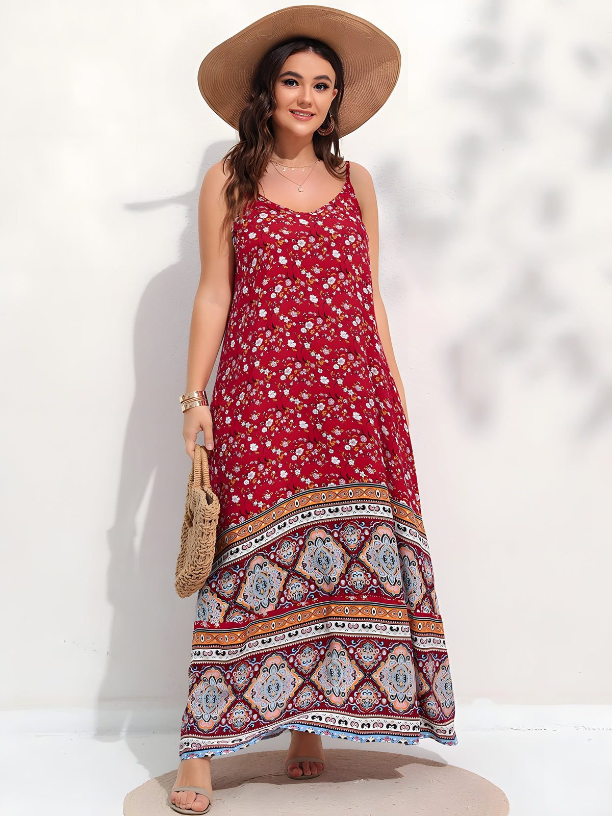 Smiling plus size model wearing red floral boho maxi dress