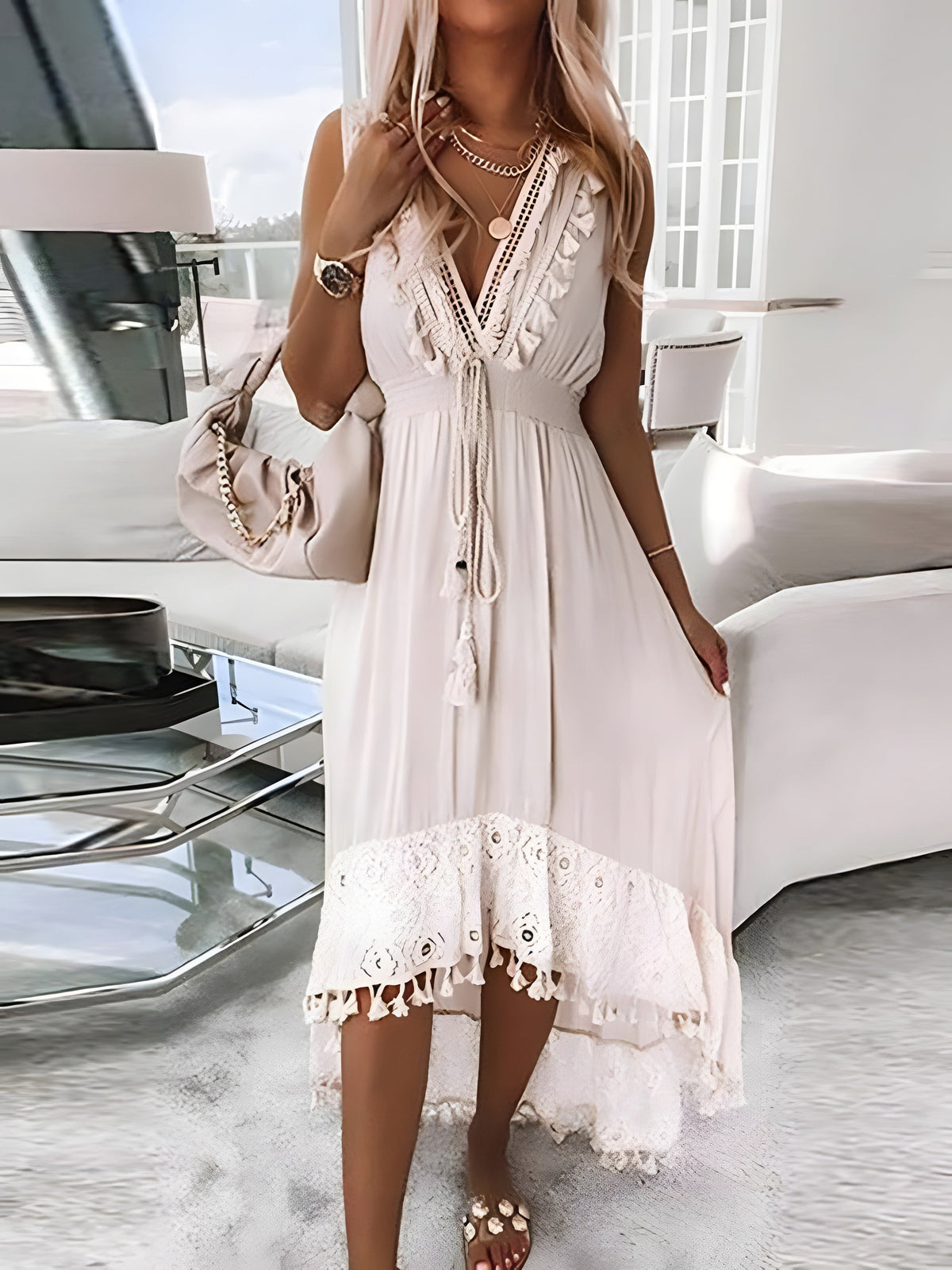 Ivory lace dress with pom-poms worn, laced V-neckline
