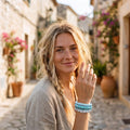 Smiling model wearing the turquoise multi strand bracelet on her wrist