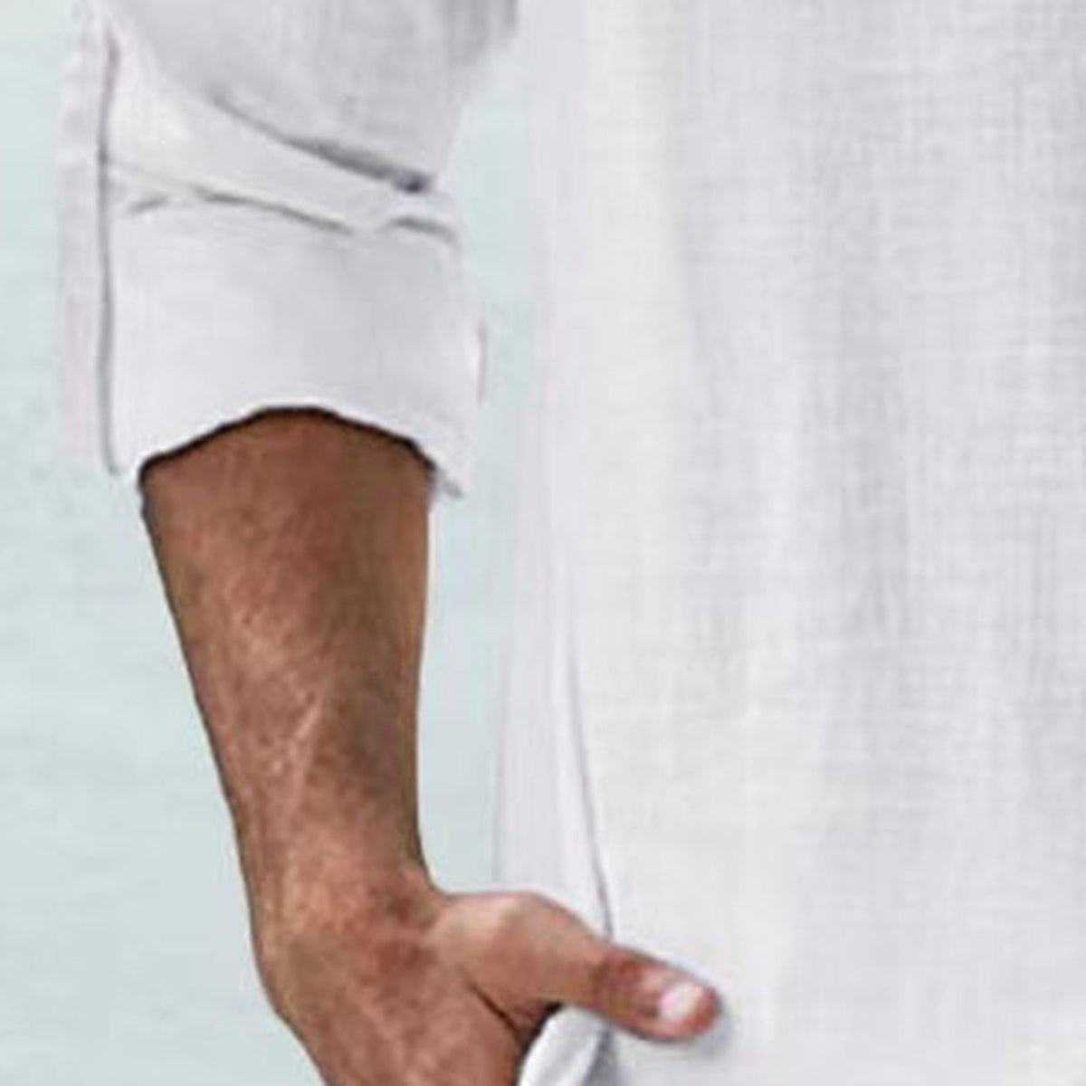 Close-up of the rolled-up long sleeve in white linen