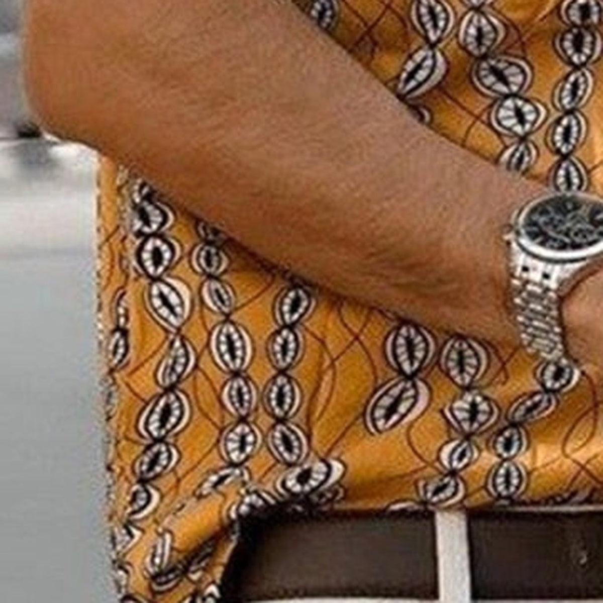 Detail of the short sleeve and cowrie print on the shirt