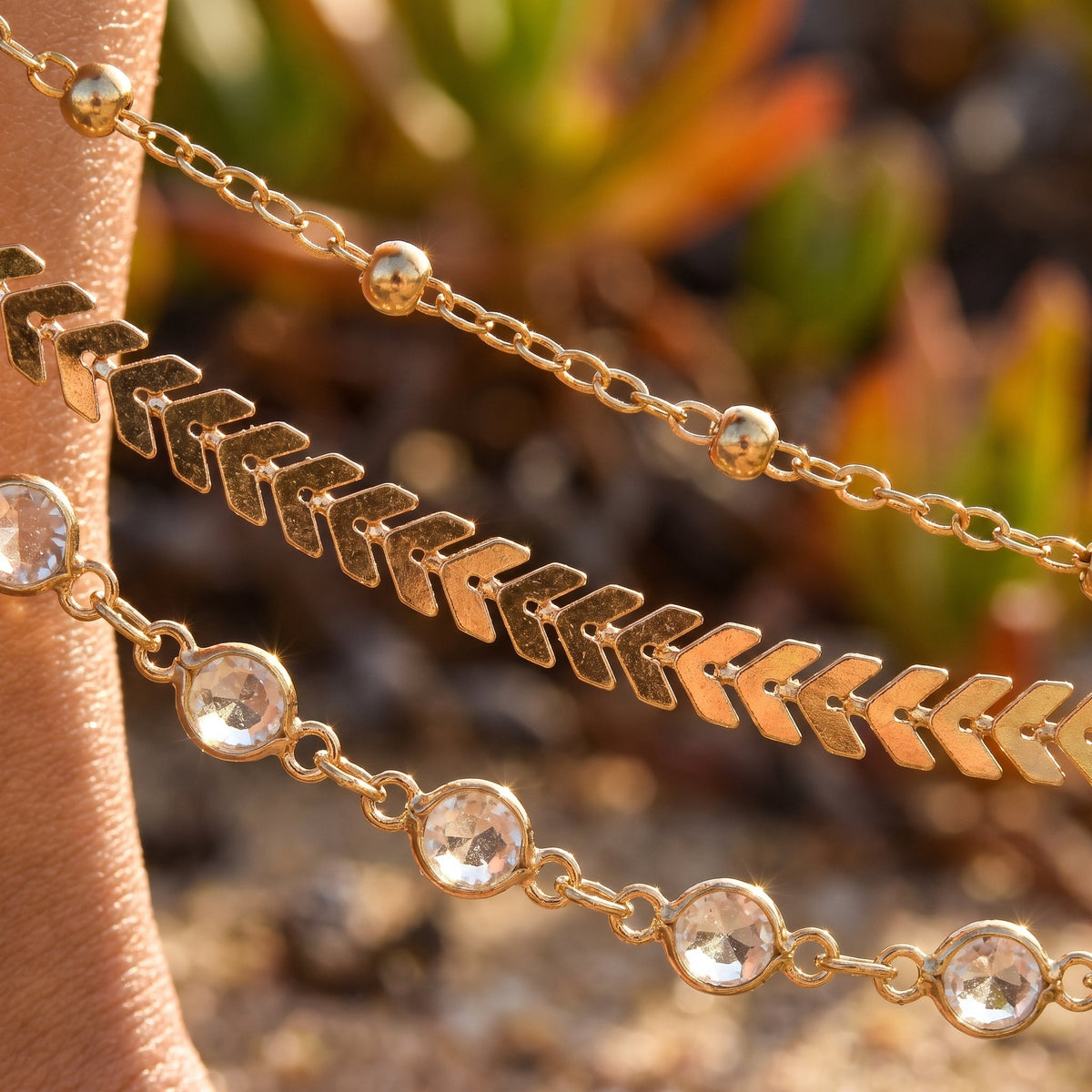 Detail of the three layered gold ankle chains