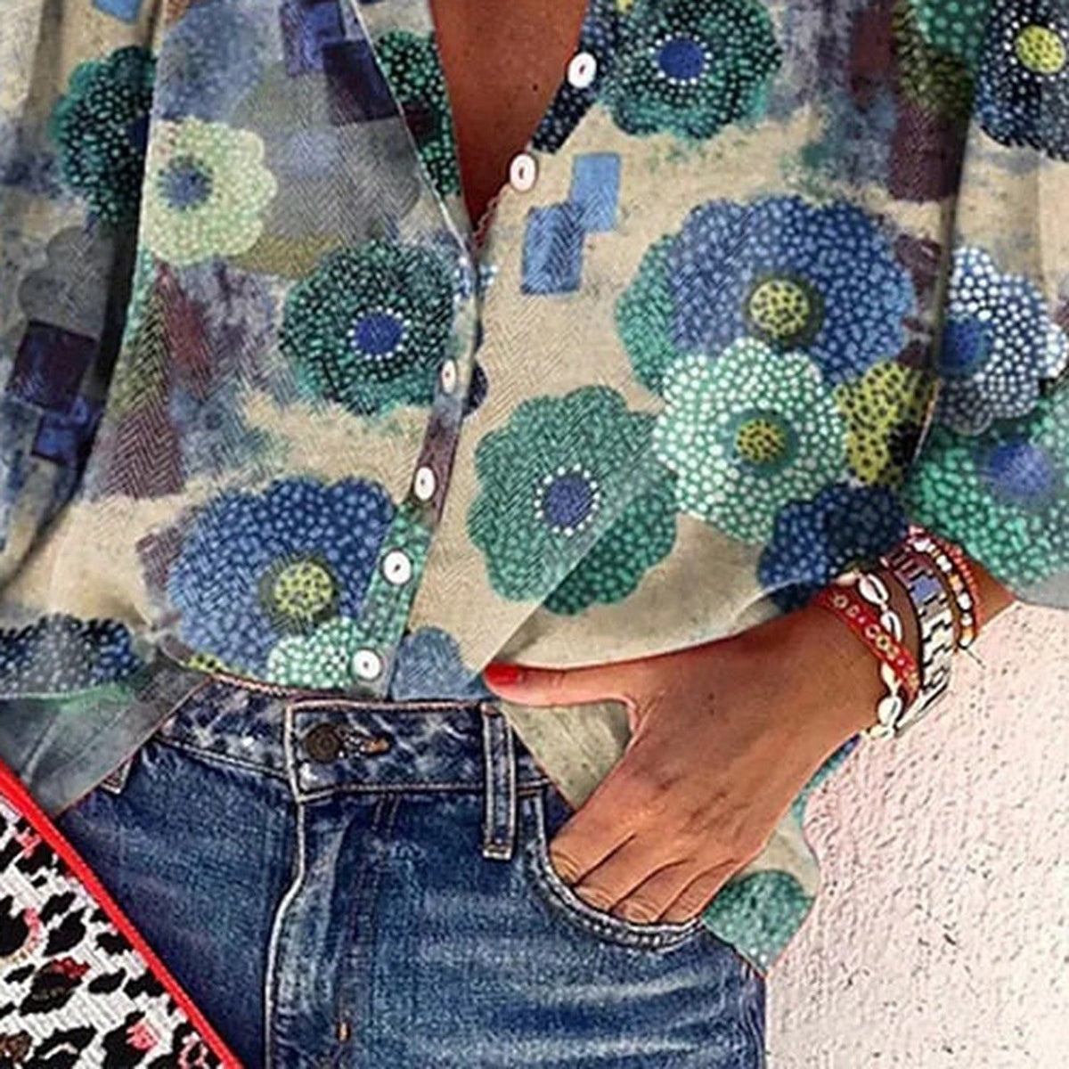 Close-up of large blue watercolor flowers tucked into jeans