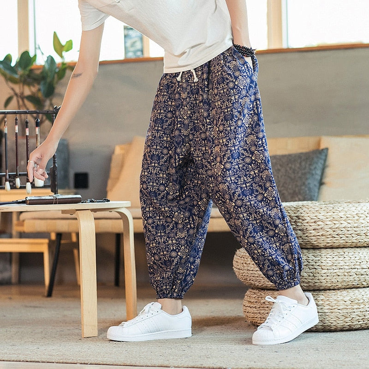 Gold colorway of the men's boho print pants worn standing