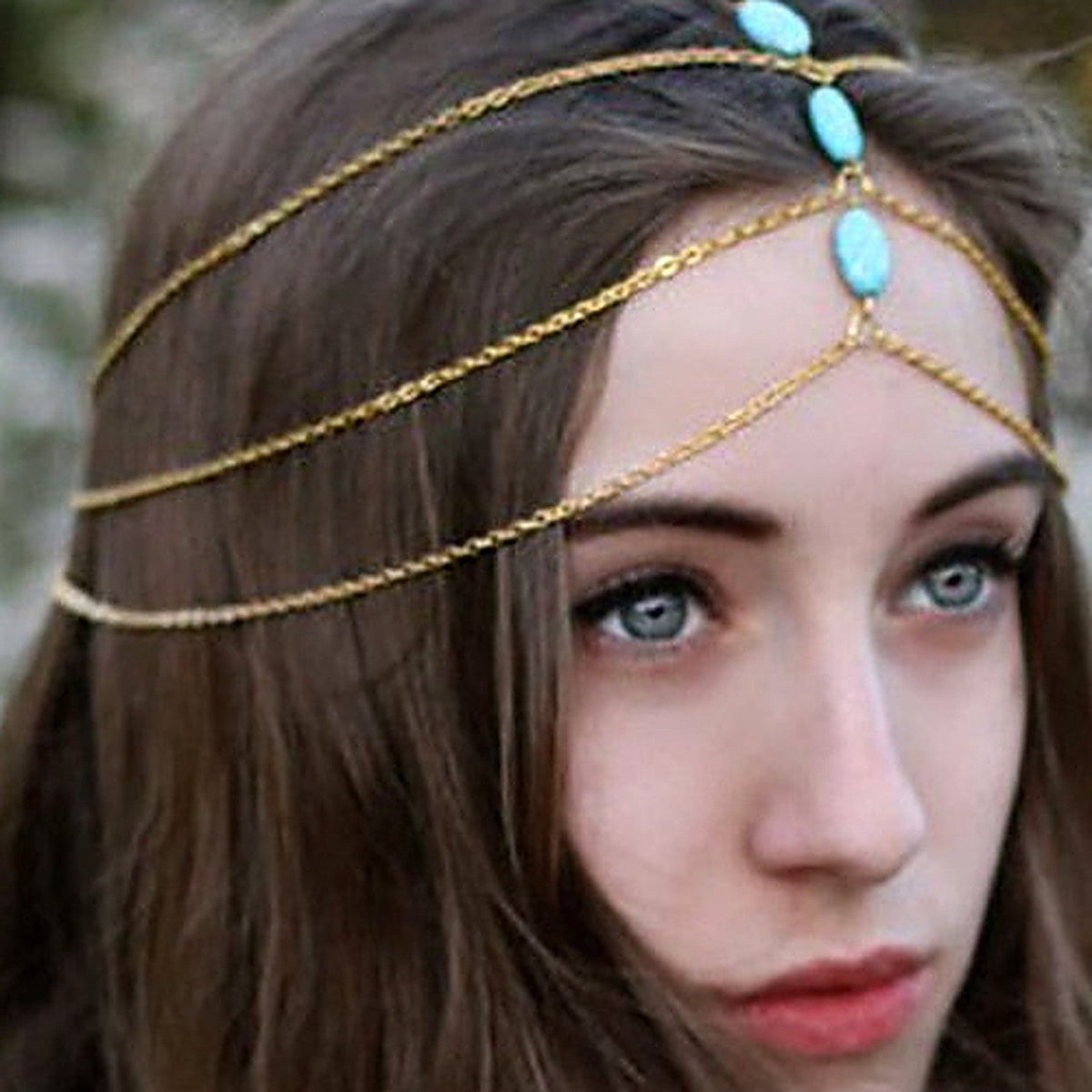 Gold chains draped through the hair, festival boho look