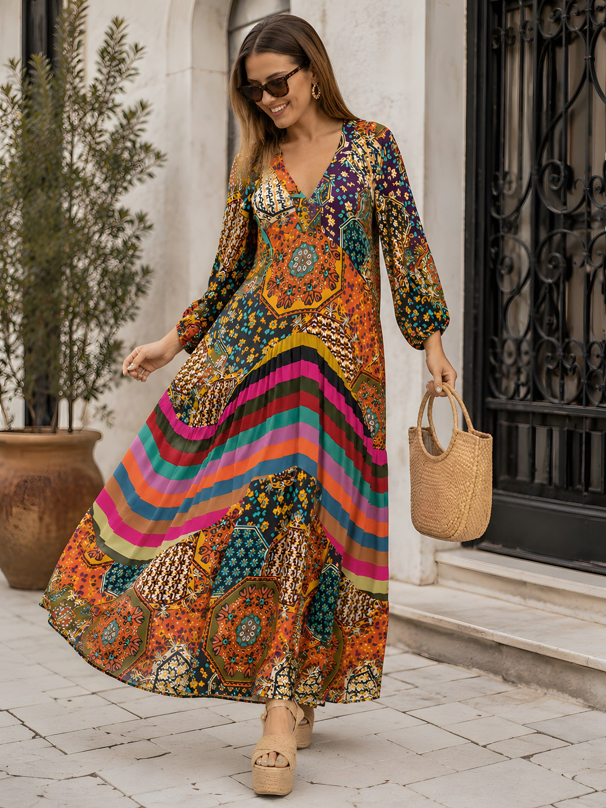 Smiling model wearing the multicolor patchwork maxi hippie dress in an alley