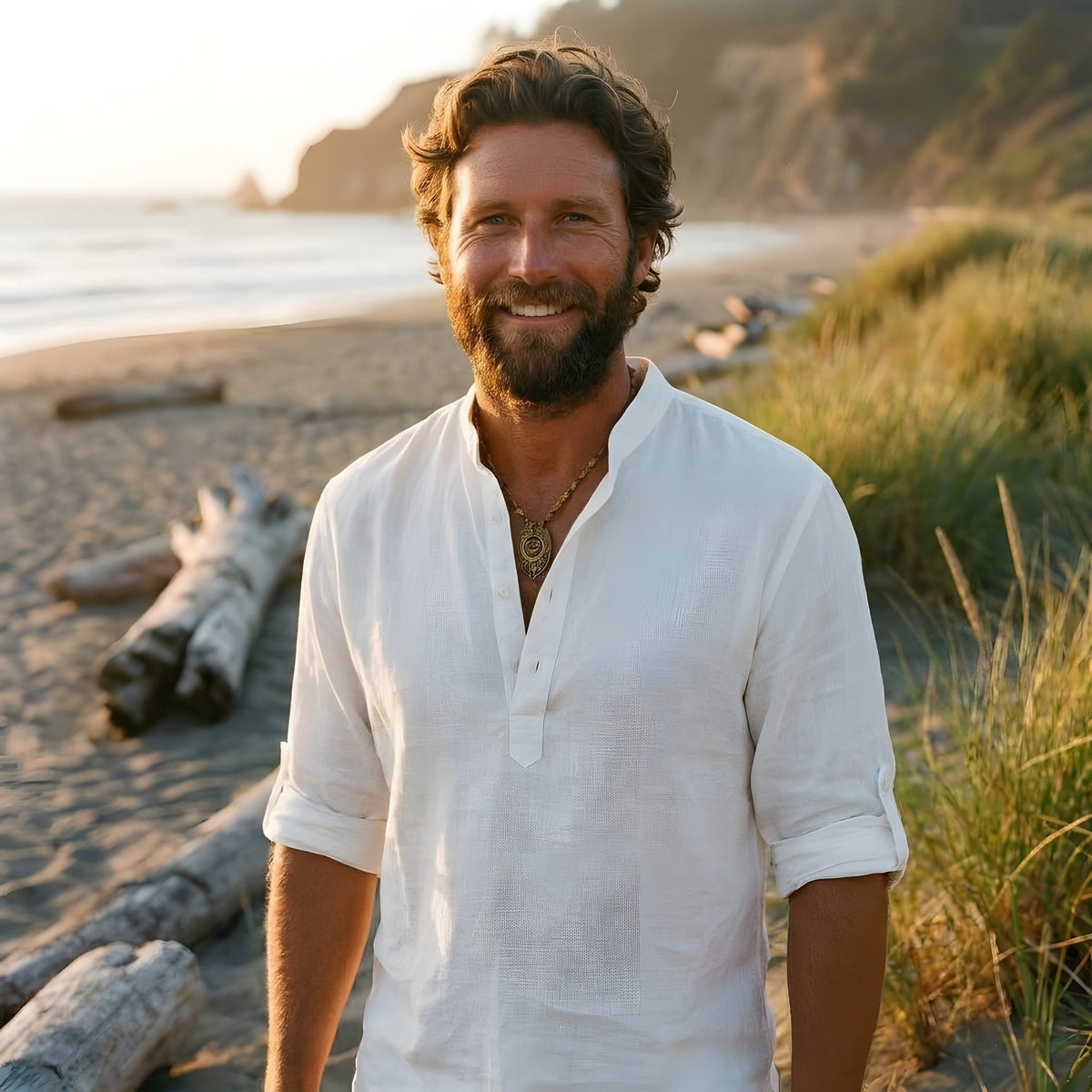 Smiling man wearing the white linen hippie shirt on the beach