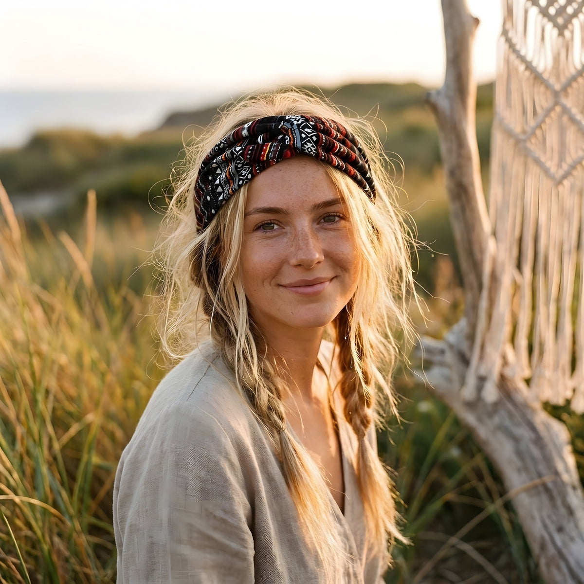 Smiling model wearing the black geometric print hippie headband