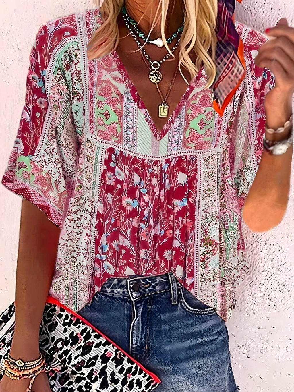 Red and pink floral blouse worn with denim shorts