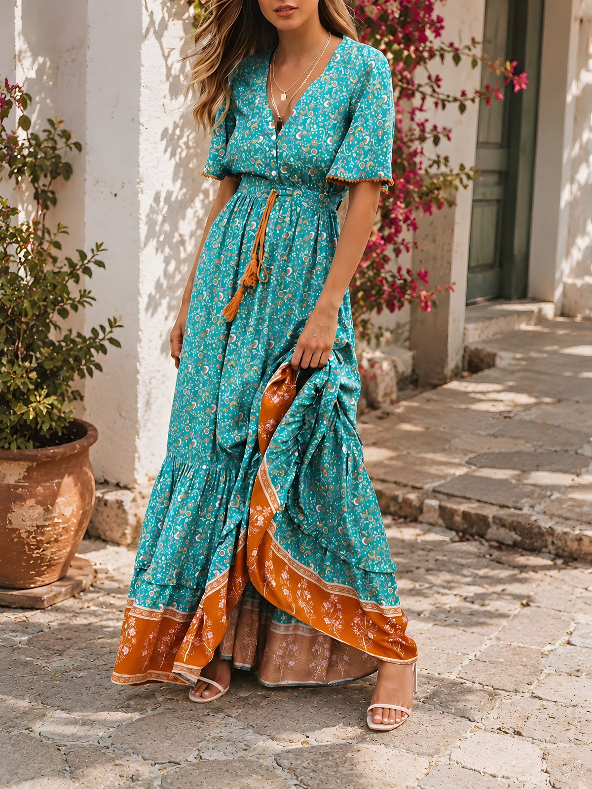 Model lifting the ruffled skirt showing the terracotta hem border