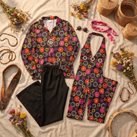 Couple wearing seventies flower power costumes with daisy print