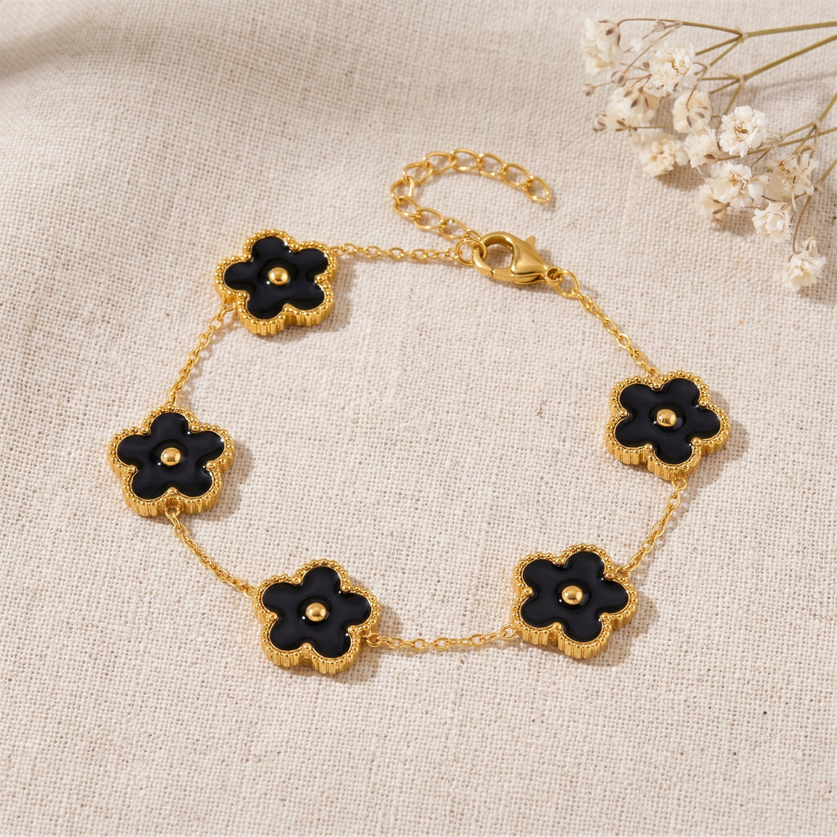 Black enamel five-petal flower bracelet with gold bead and chain