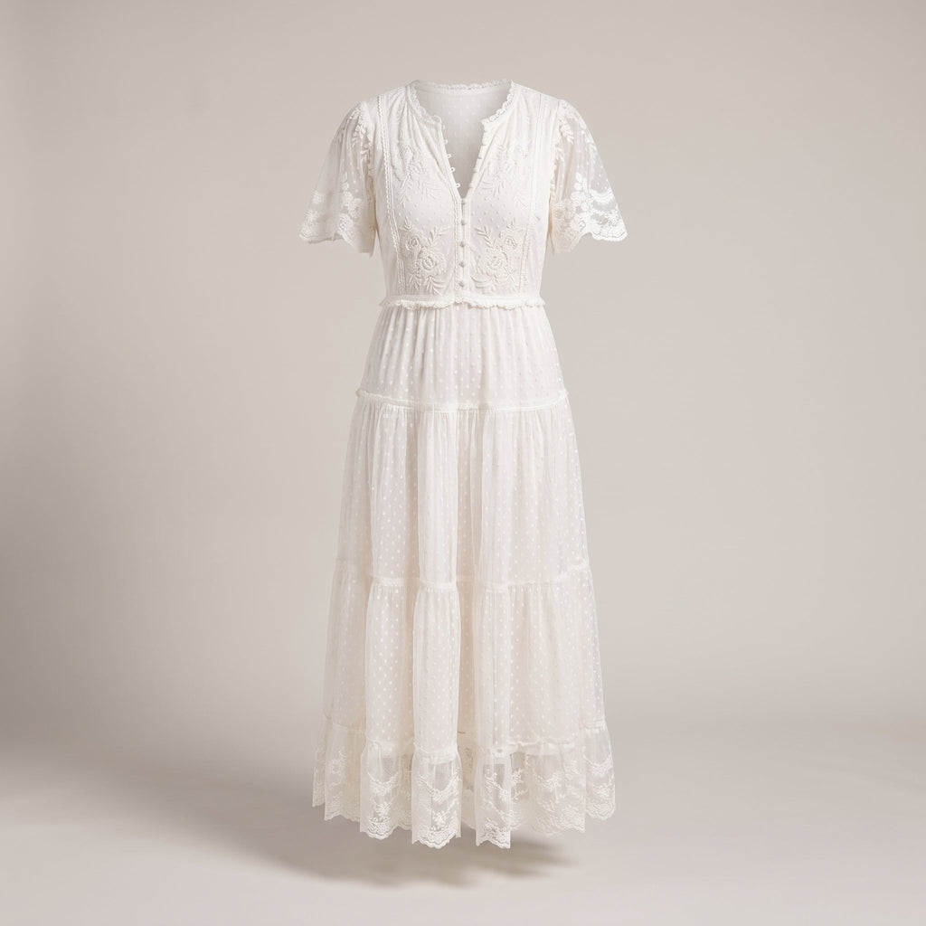 White dotted Swiss lace maxi dress on a studio background