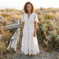 White lace boho maxi dress worn by a smiling model