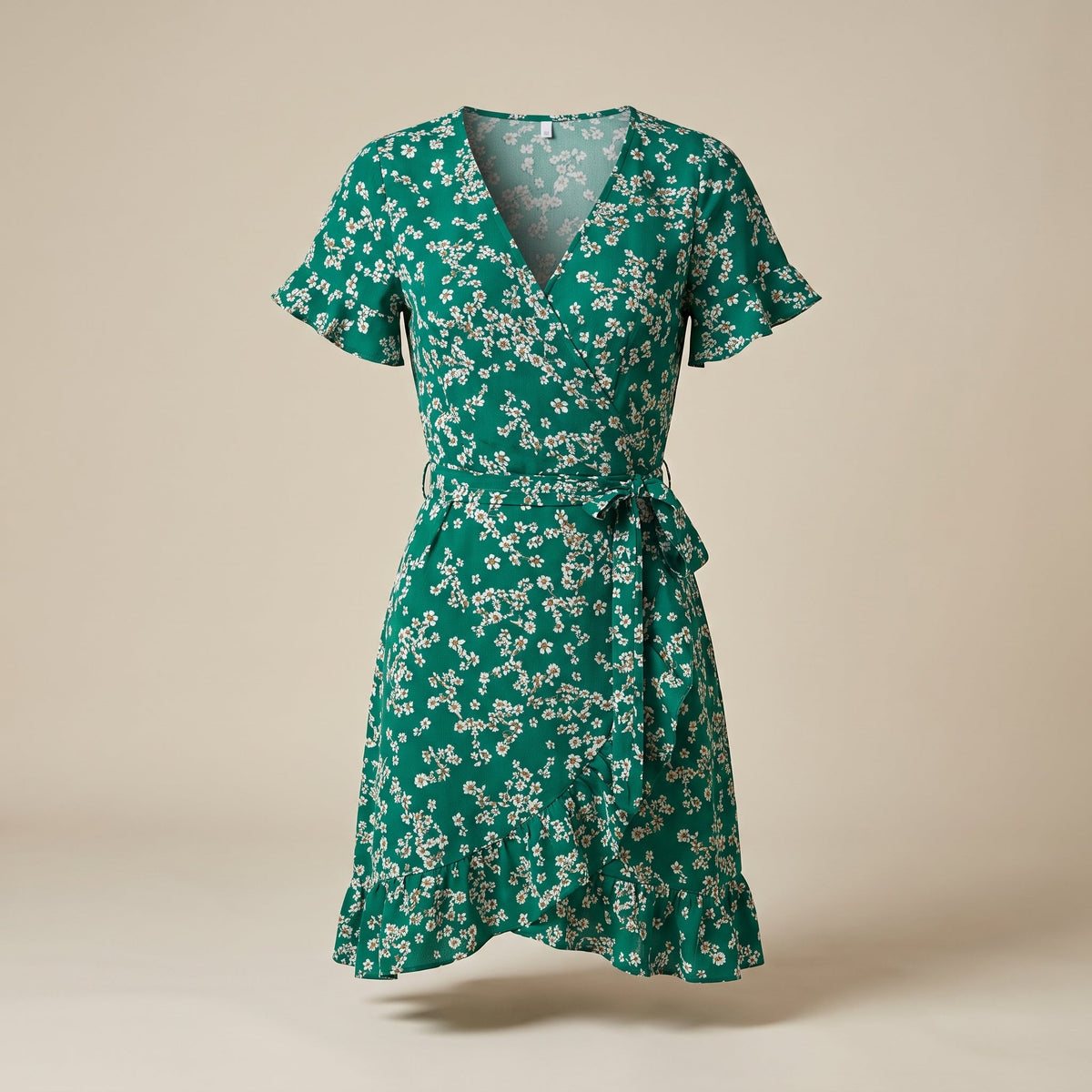 Green floral wrap dress on an invisible mannequin, studio view