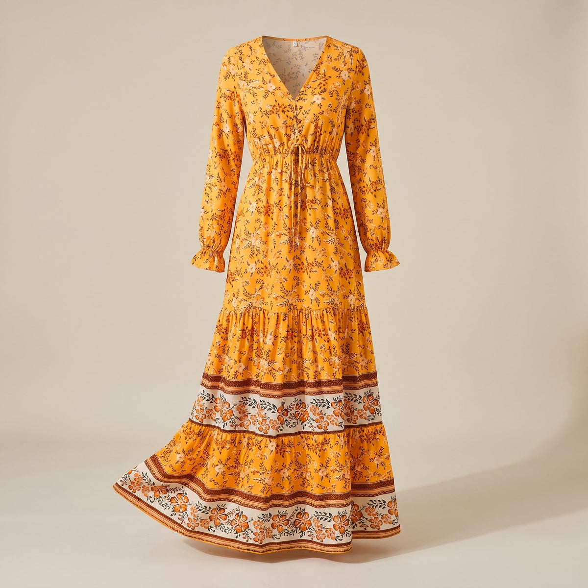 Yellow floral maxi dress with ruffled hem on a ghost mannequin