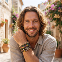 Smiling model wearing the men's hippie bracelet set