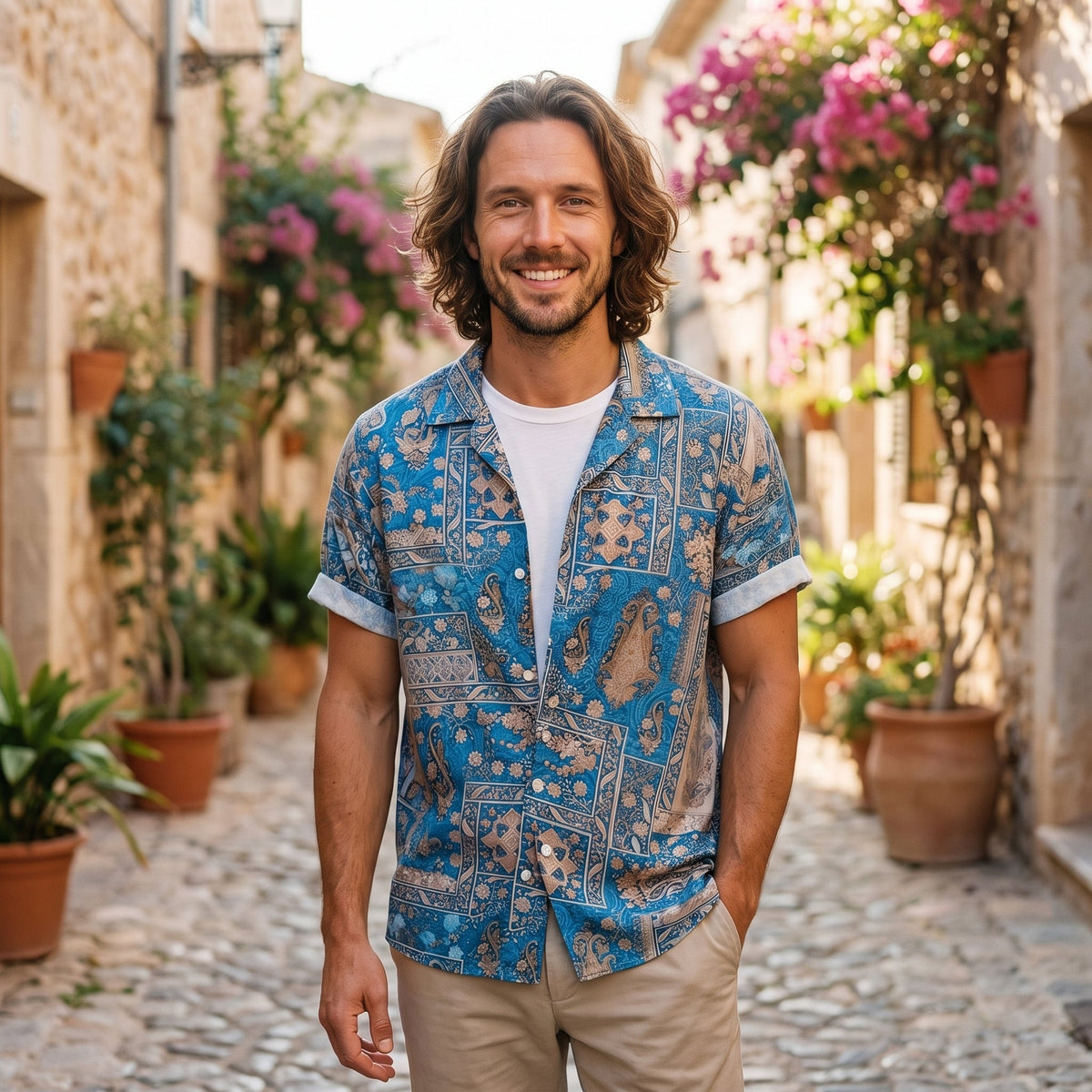 Smiling man wearing the blue paisley print camp collar shirt