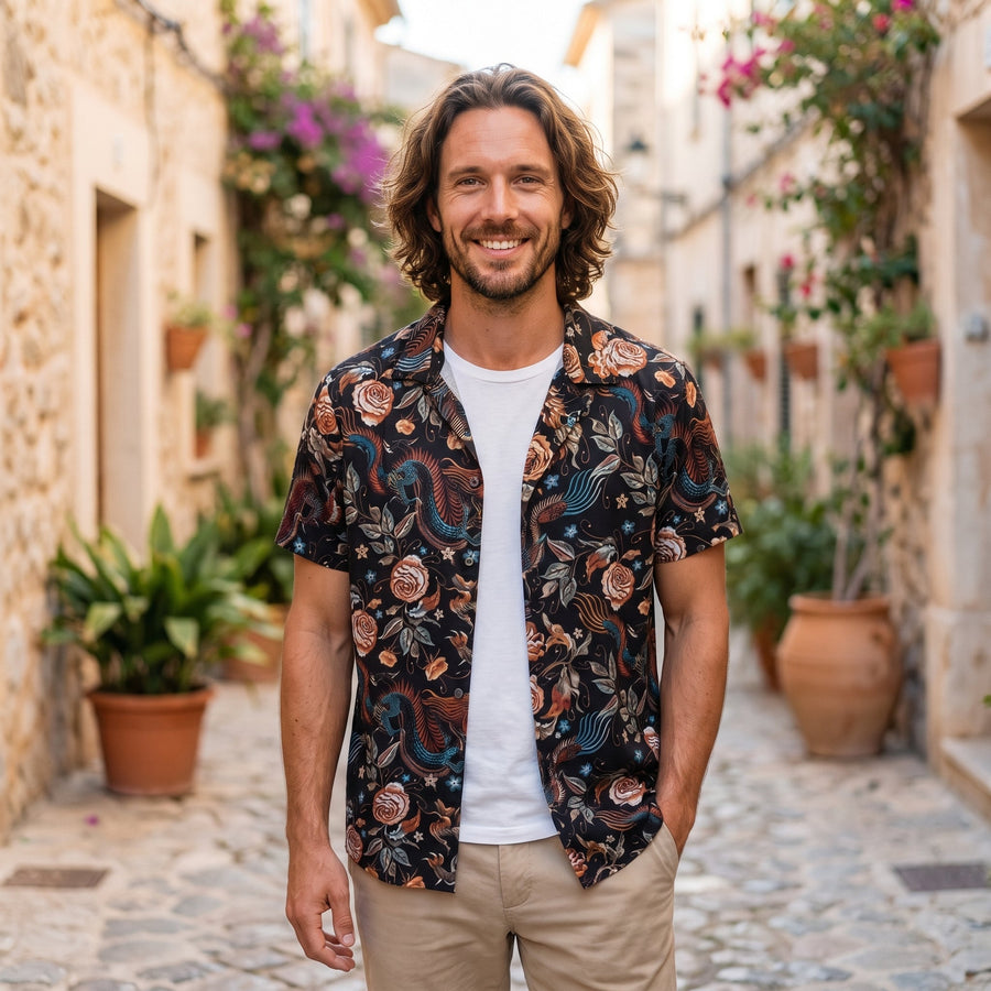 Smiling man wearing the black floral print hippie shirt