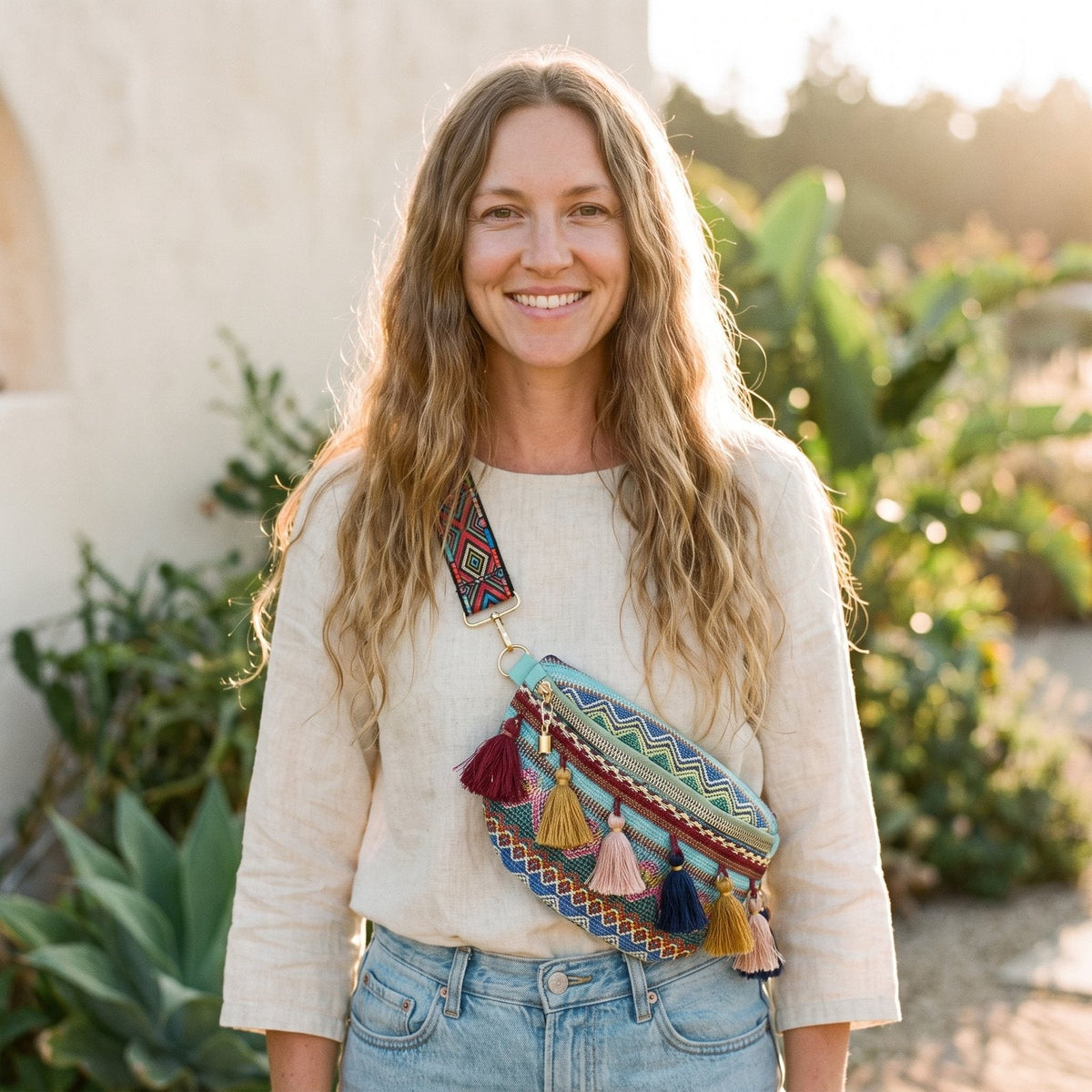 Smiling model wearing the boho hippie fanny pack crossbody