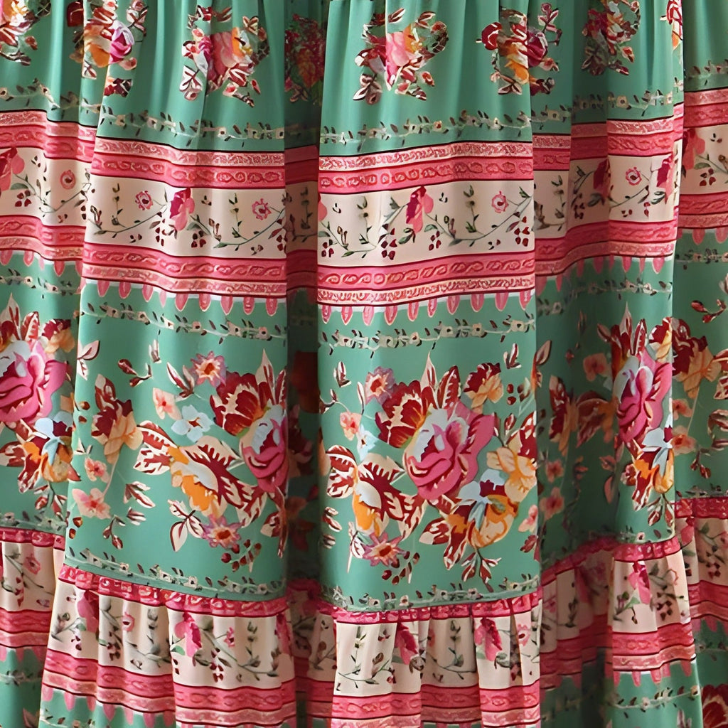 Close-up of the floral print on emerald green and woven border