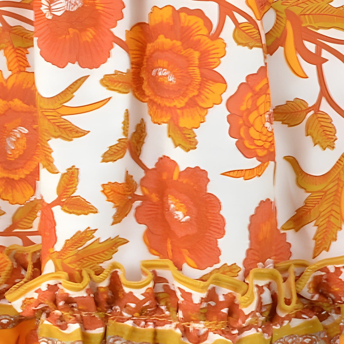 Close-up of the orange floral print and block-print border