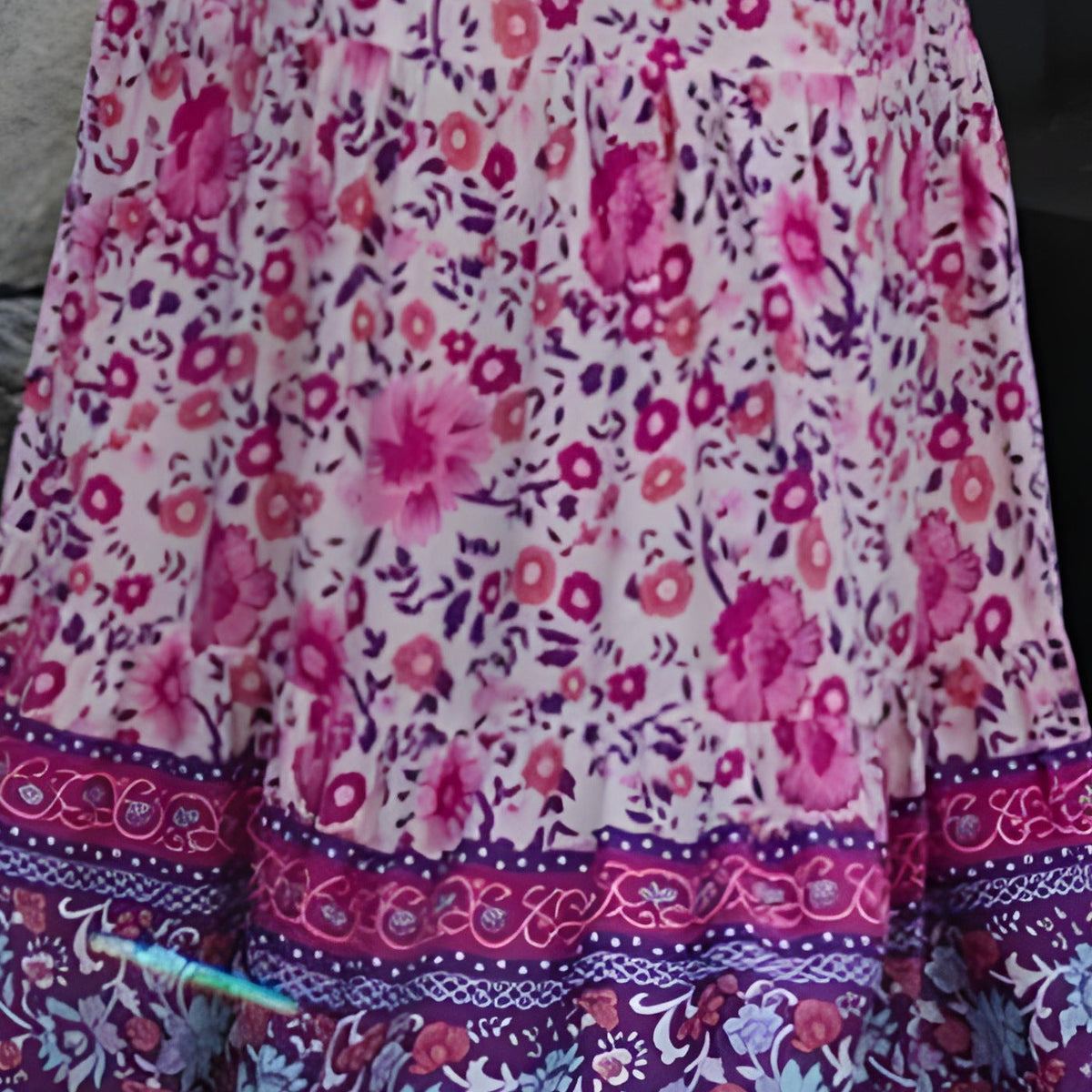 Close-up of the pink floral print and purple woven border