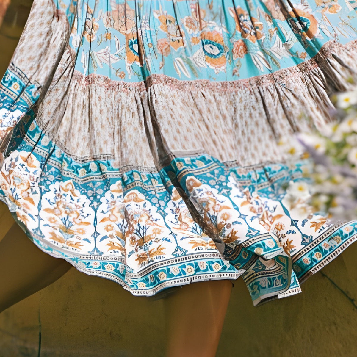Close-up of the turquoise floral print and block-print border