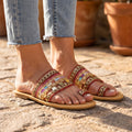 Beaded flat boho sandals worn on Mediterranean cobblestones
