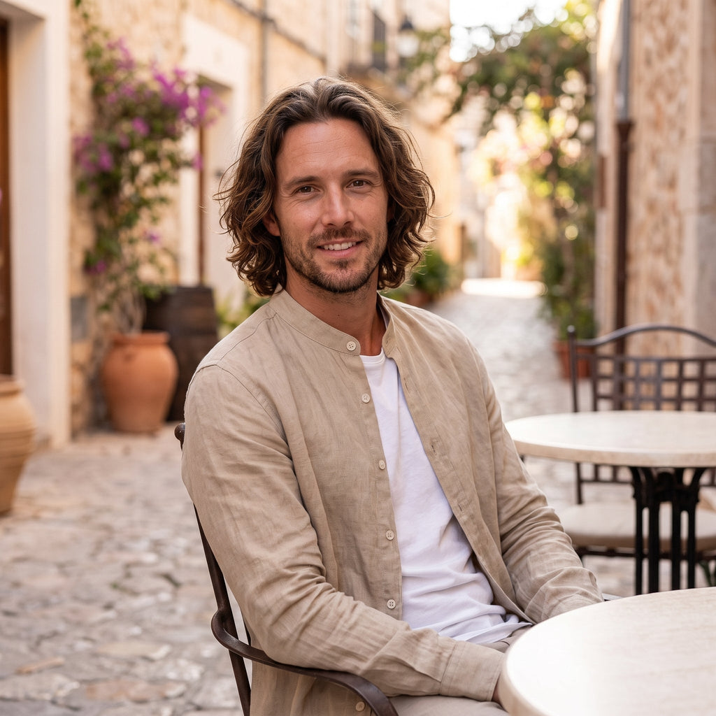 Man seated at a terrace wearing beige linen-look shirt