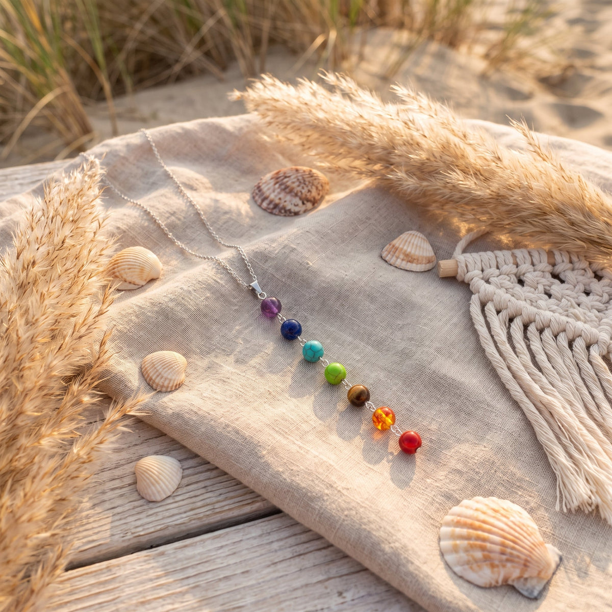Colorful chakra beads sliding along the steel necklace chain