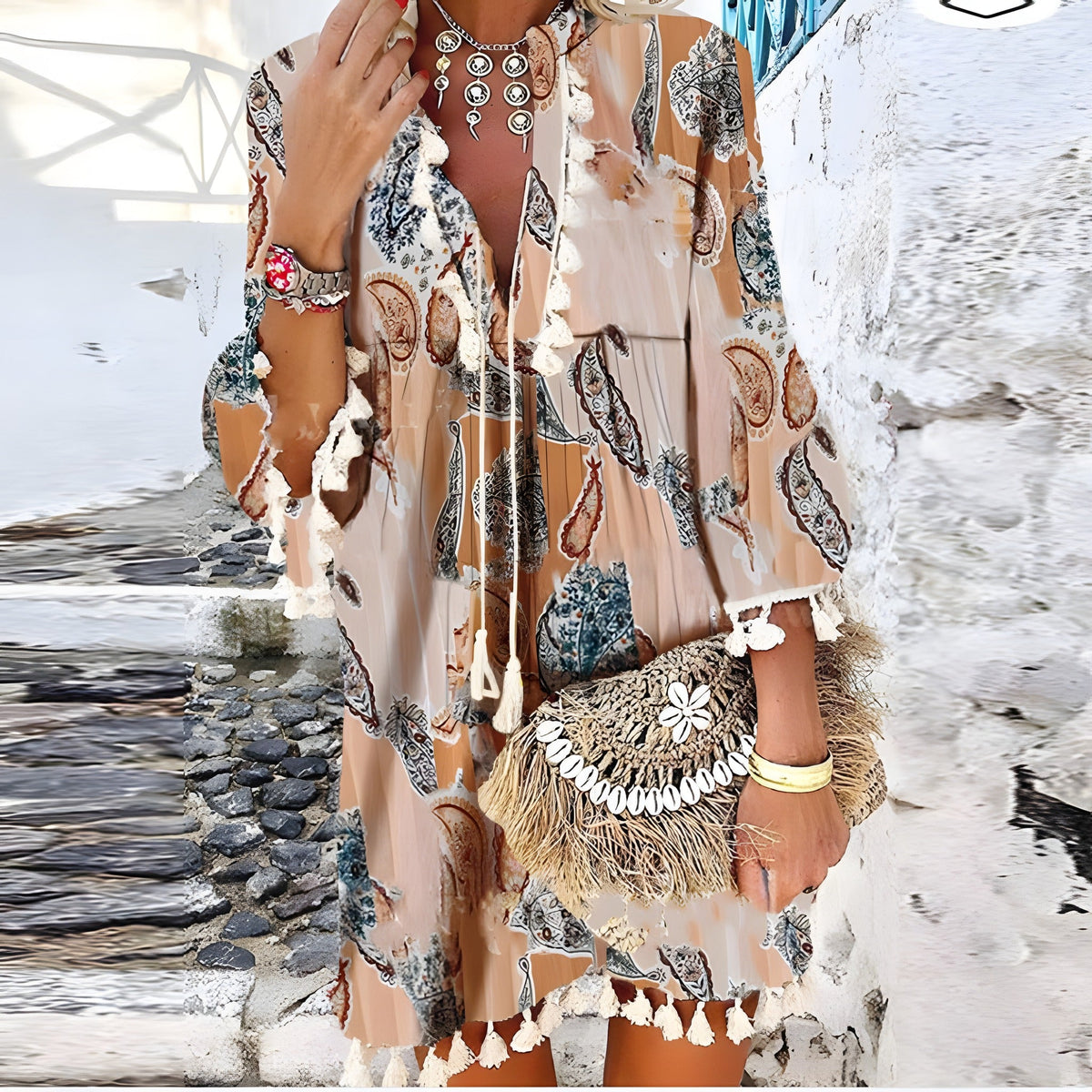 Pompom-trimmed paisley dress worn in a relaxed lifestyle setting