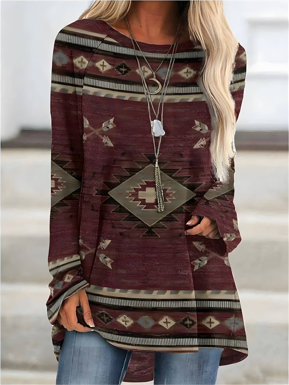 Burgundy Aztec print tunic with a flowy cut covering the hips