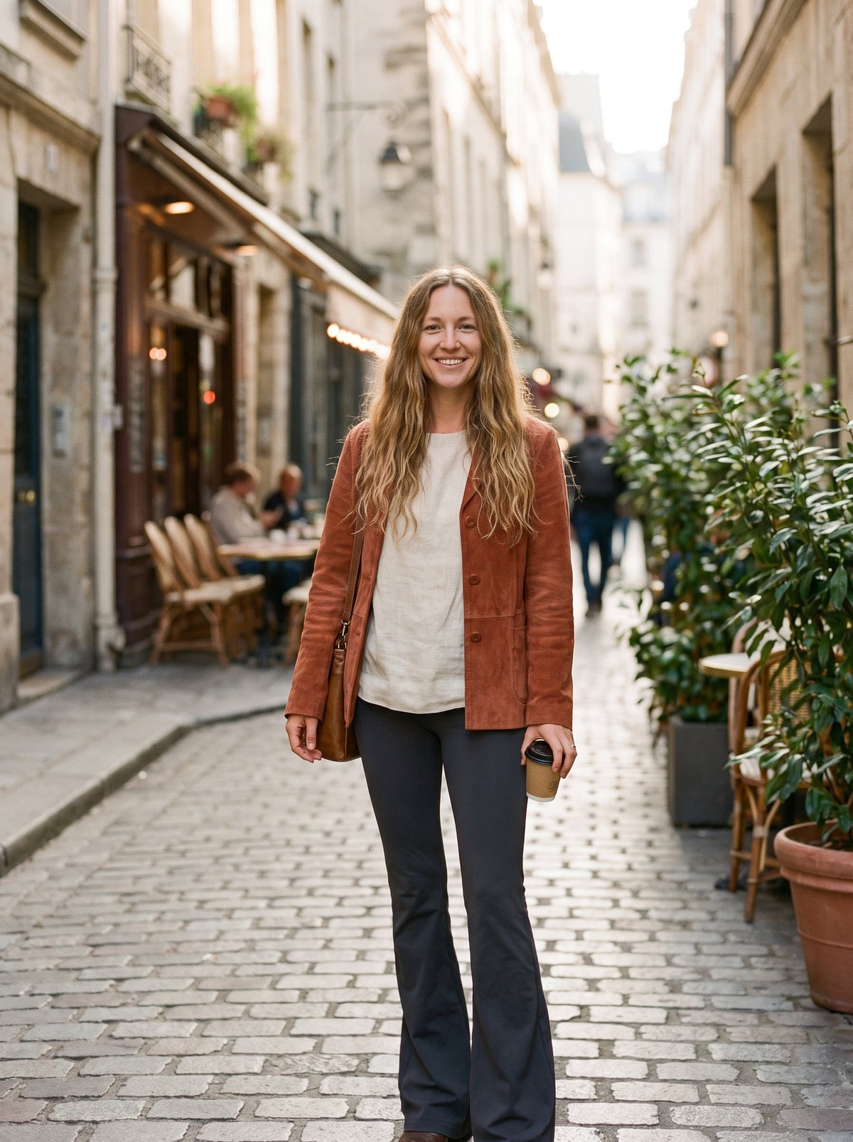 Model wearing flowy black bell bottom pants in a city street