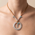 Hammered ring and silver feather pendant on suede cord, worn
