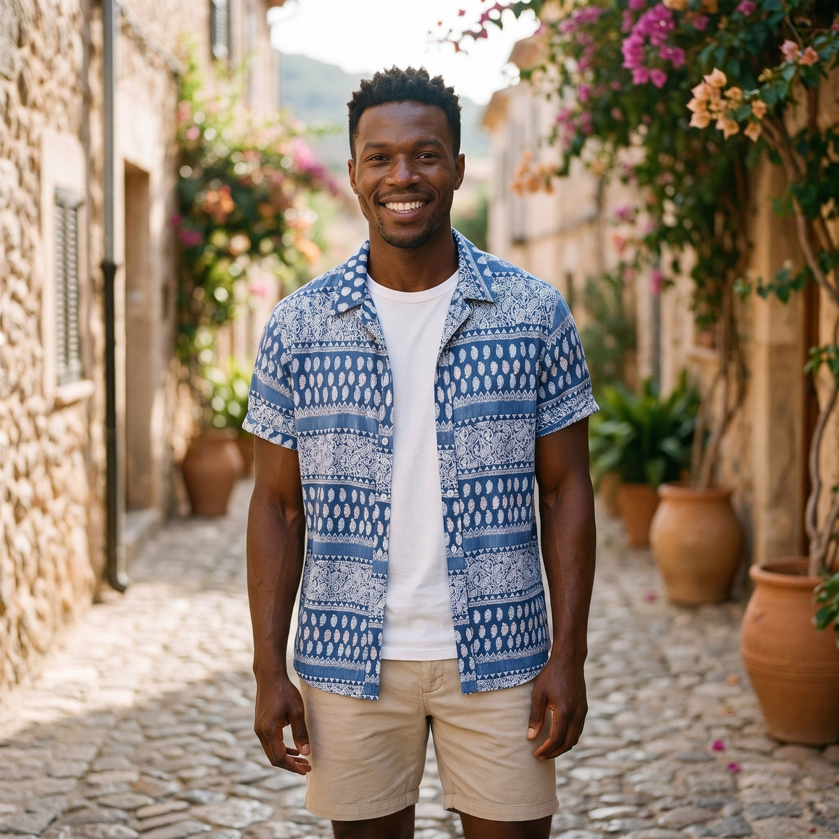 Smiling man wearing the blue Indian print cotton hippie shirt