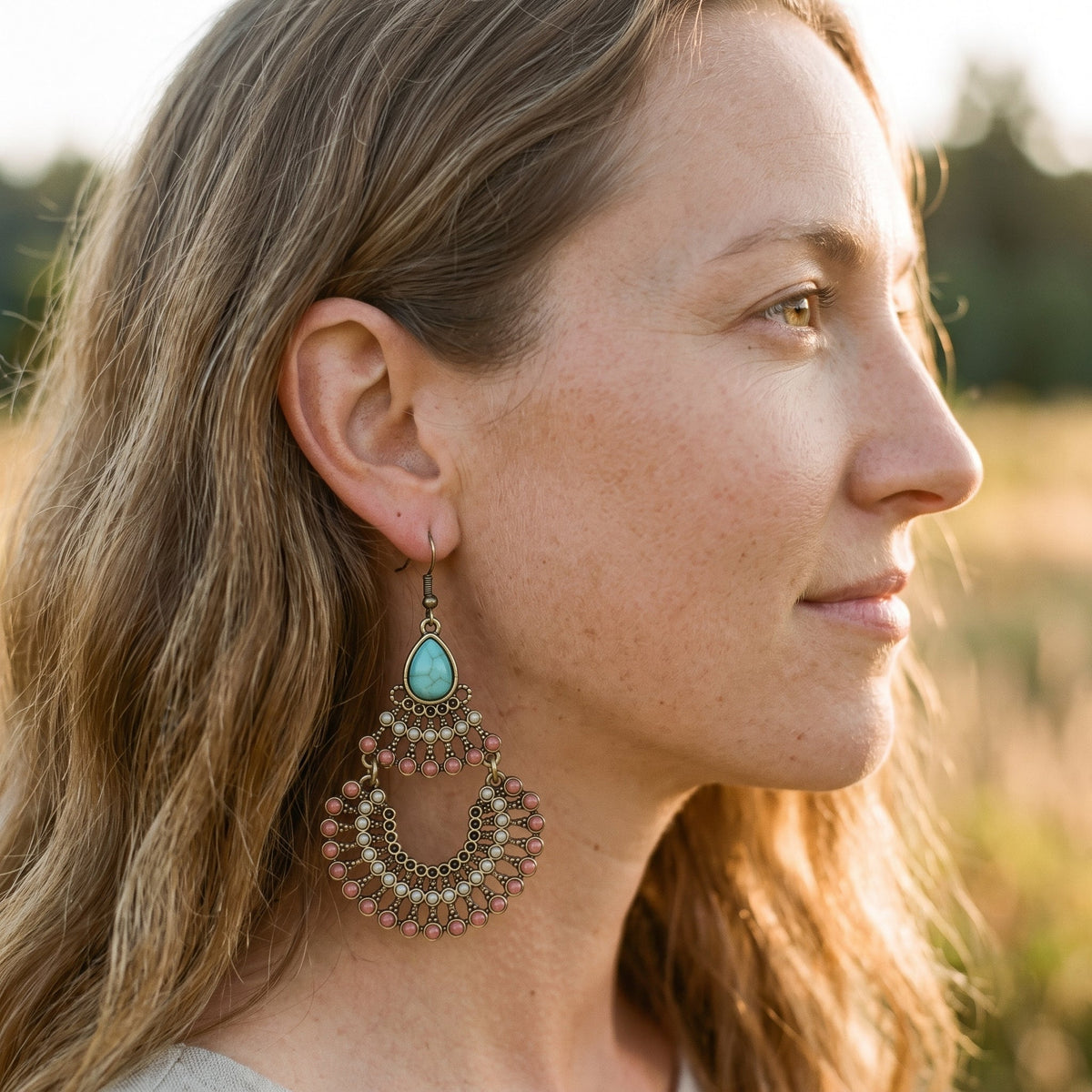 Turquoise drop earrings worn close to the ear, boho look
