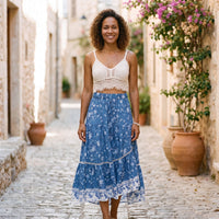 Denim blue floral maxi hippie skirt worn by a smiling model