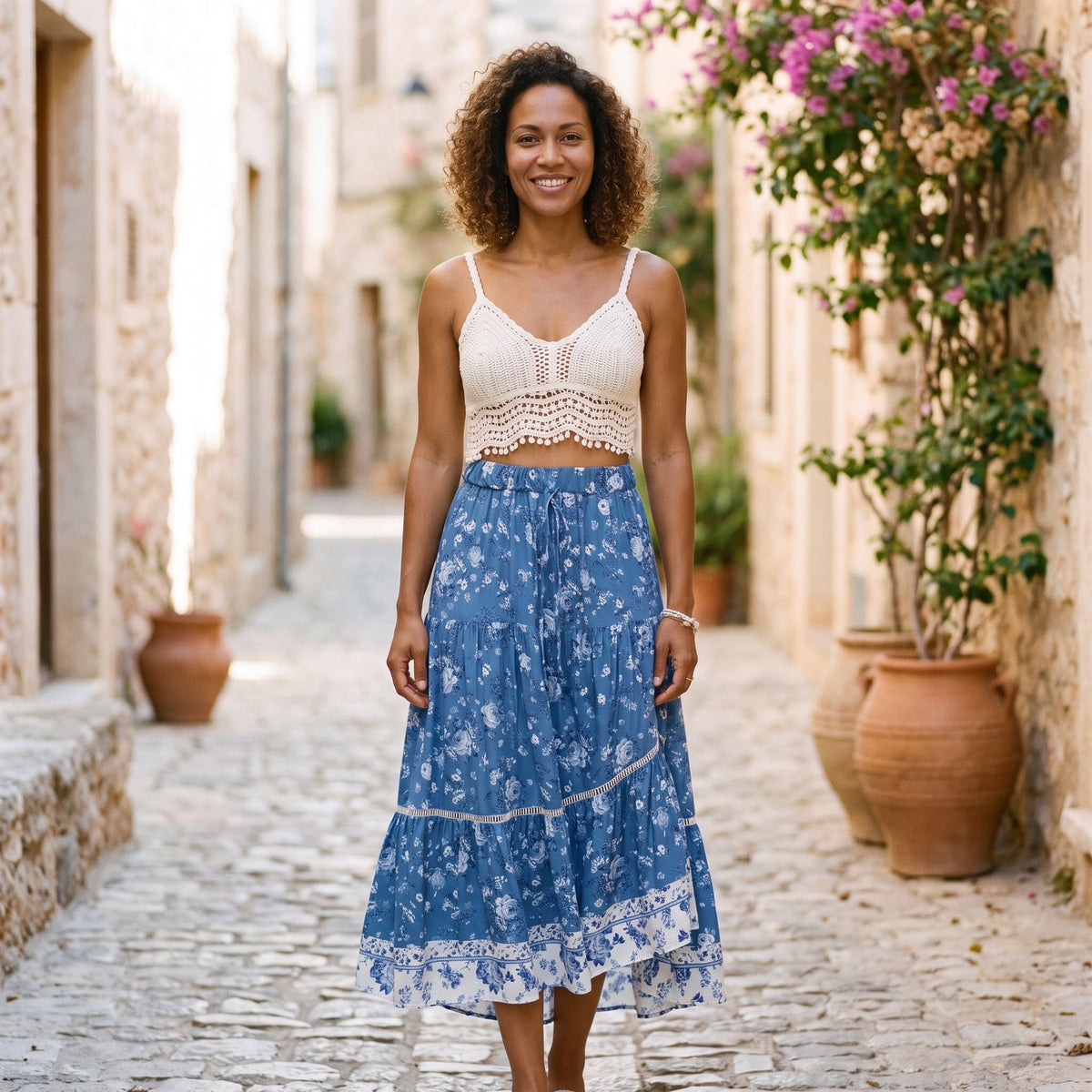 Denim blue floral maxi hippie skirt worn by a smiling model