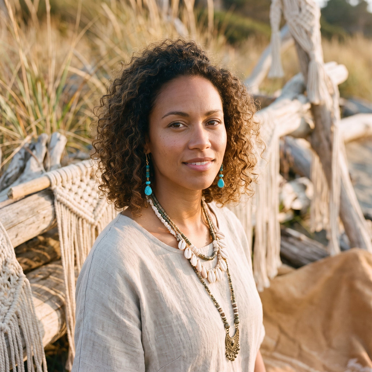 Turquoise and gold drop hippie earrings worn by a model