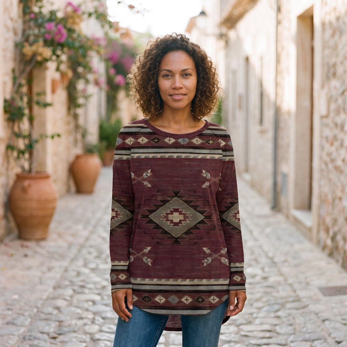Burgundy Aztec print long tunic worn by a smiling model