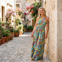 Blue paisley hippie jumpsuit worn by a smiling model