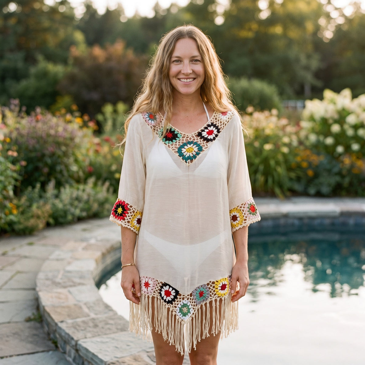 V-neck crochet beach tunic worn by a smiling model poolside