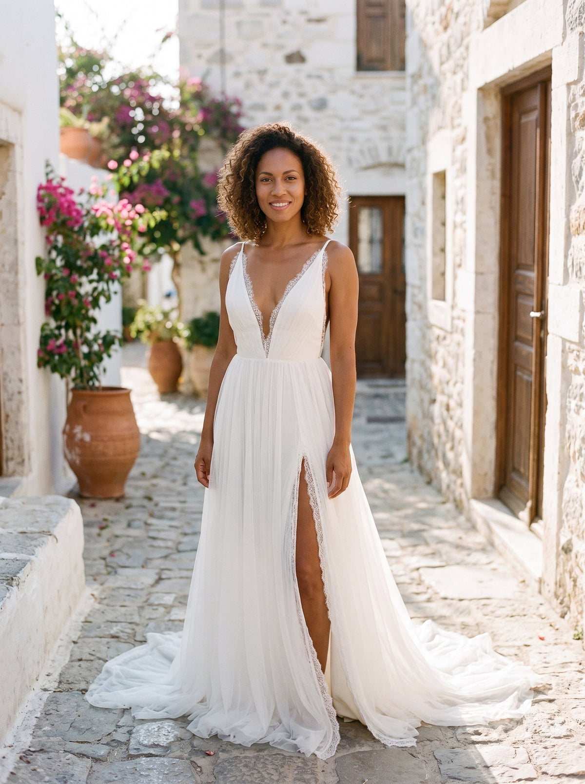 Smiling model in the white chiffon and lace boho wedding dress