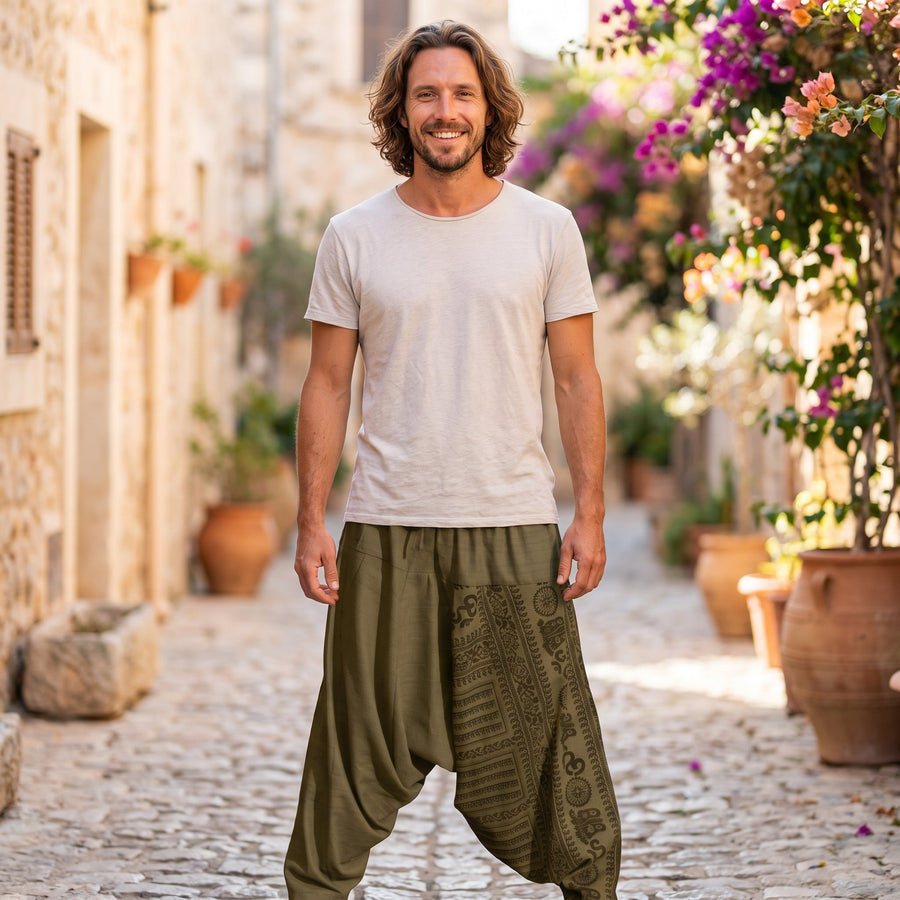 Smiling man wearing green harem pants in a Mediterranean alley