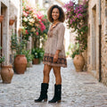 Smiling woman wearing the black fringe heeled boots