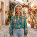 Green floral blouse with balloon sleeves worn by a smiling model